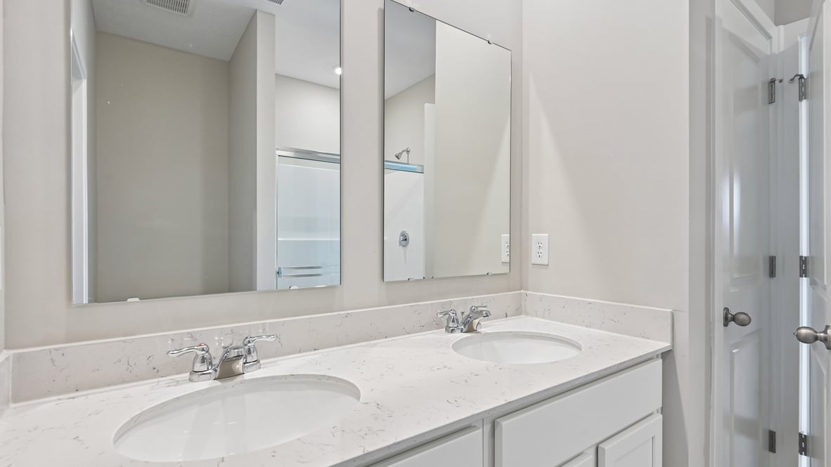 primary bathroom with dual vanity
