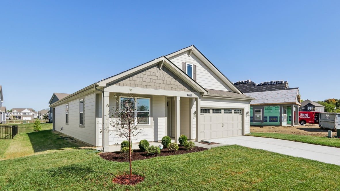 exterior view of ranch home with light brown siding