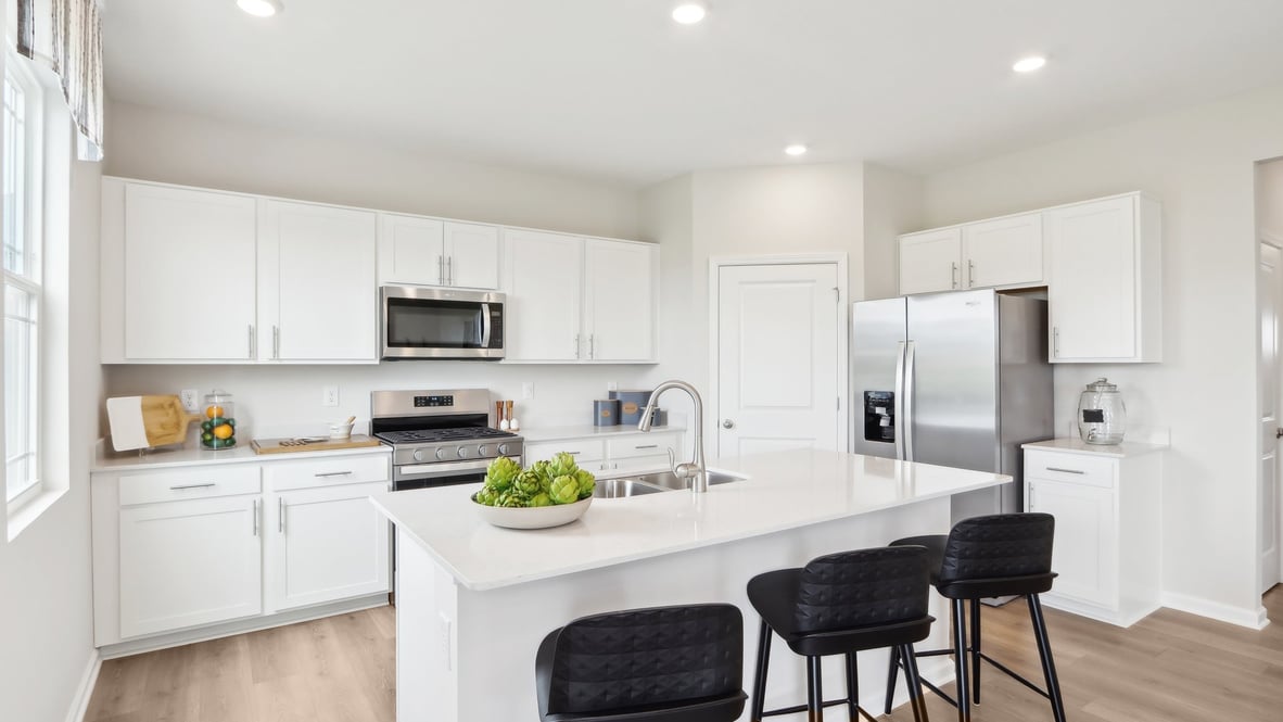 View over the kitchen island with sink highlighting prep space and connection to surrounding areas Mt. Vernon North