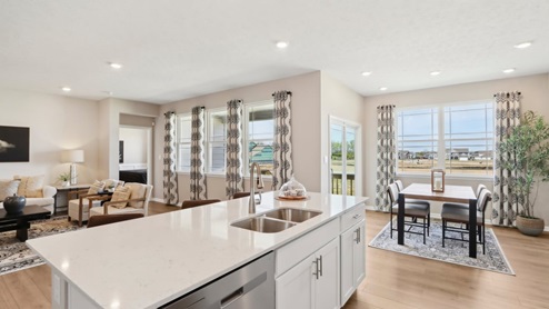 kitchen island overlooking dining nook and great room