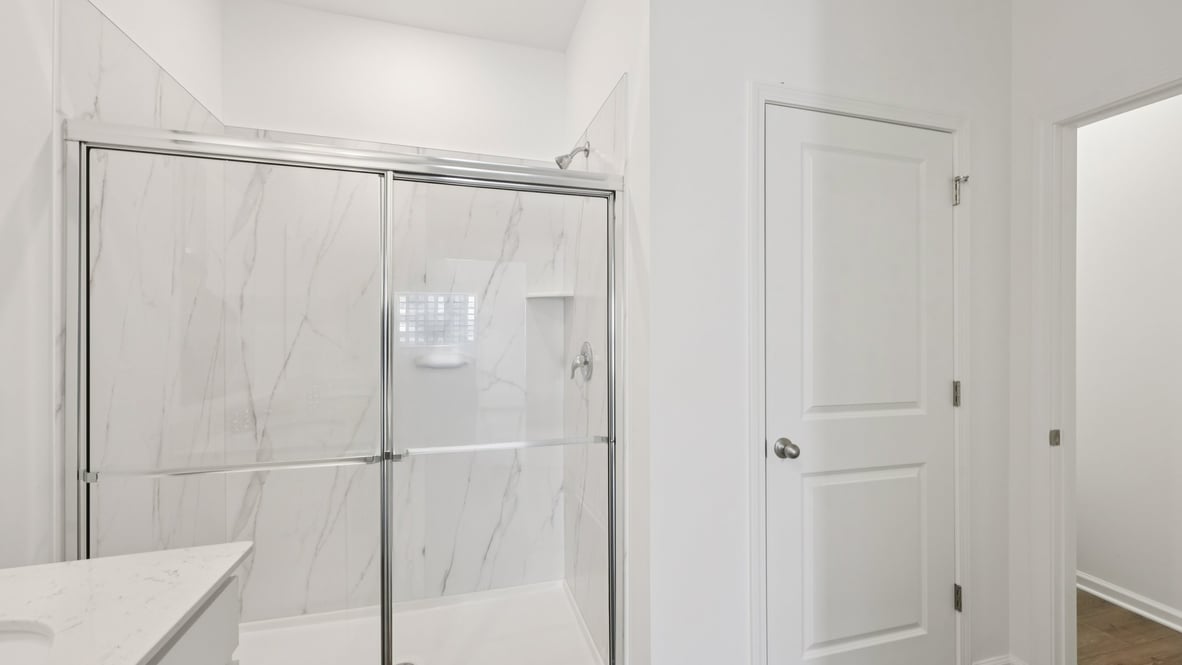 Owner’s ensuite view in our new build home offers function and style with a walk-in closet, spa-like ensuite