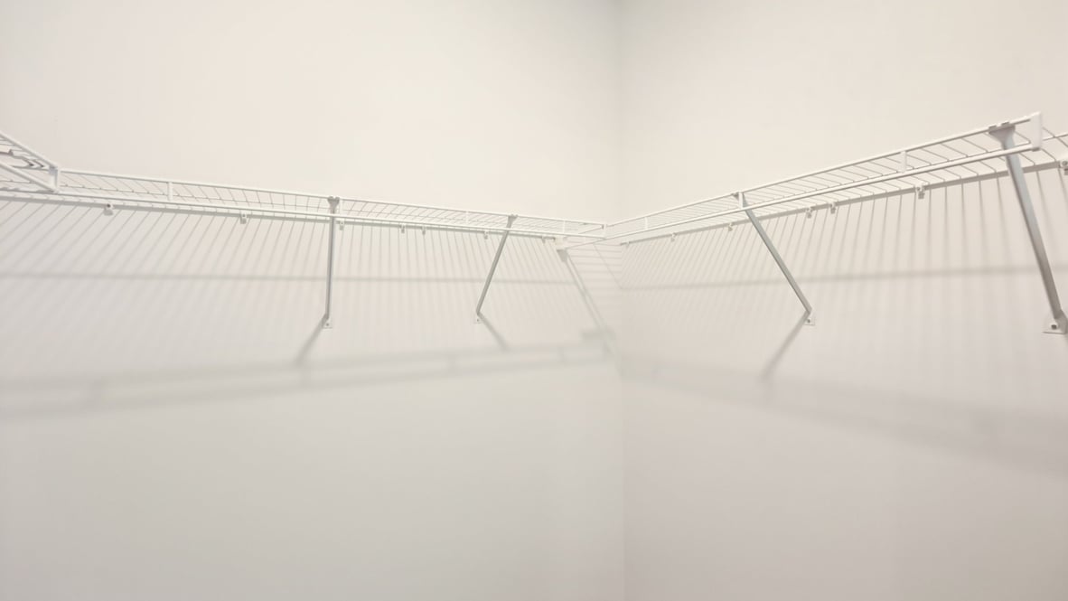 Primary suite walk-in closet view new home with built-in shelving and generous storage