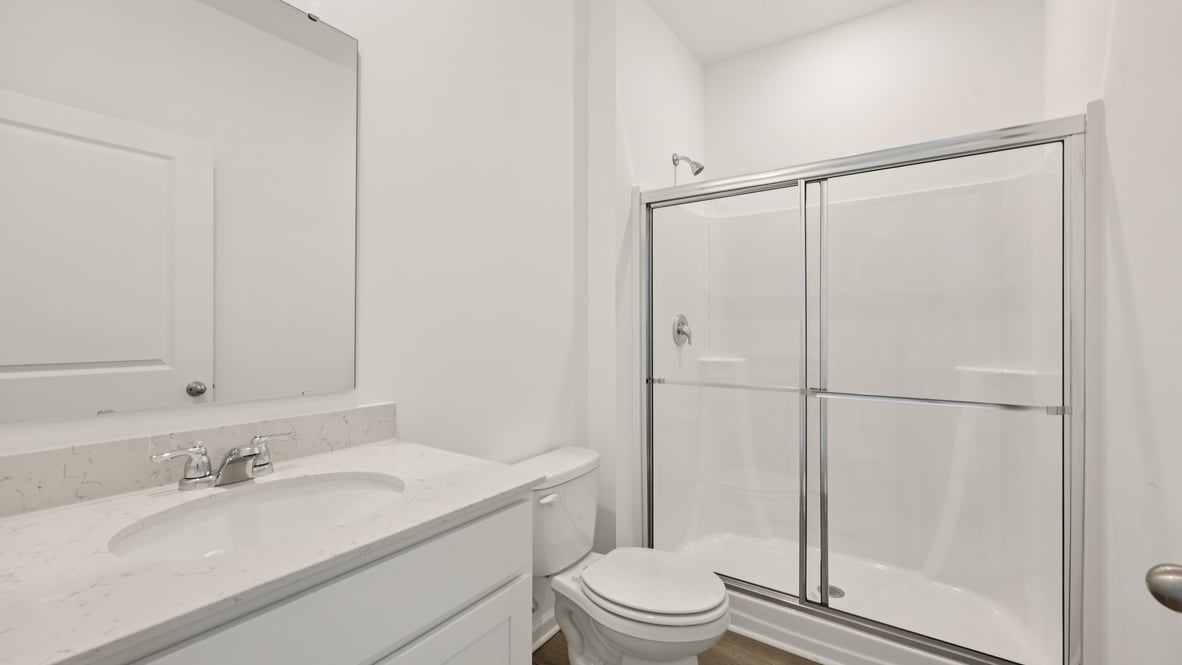 Modern owner’s ensuite bathroom layout offering spa-inspired comfort with double vanity and walk-in shower