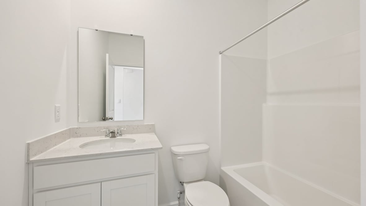 Family full bathroom adds stylish vanity, mirror, cabinets, and tub-shower combo