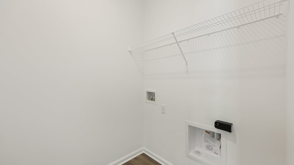 Utility laundry smartly designed with overhead shelving and washer and dryer included