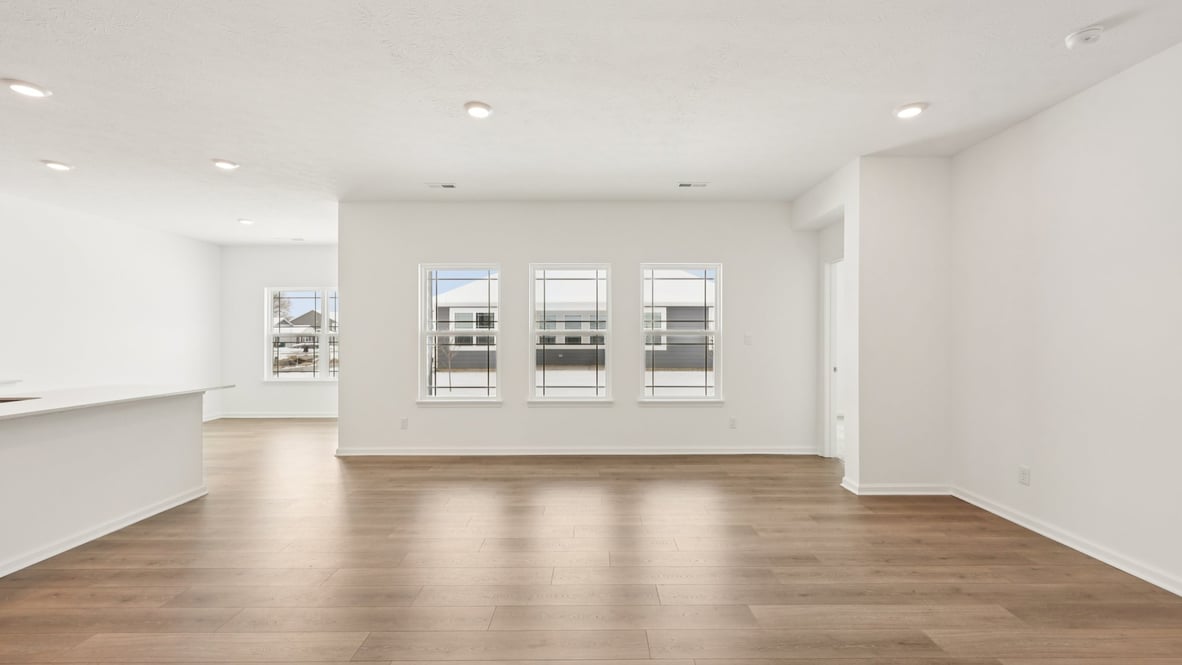 View from living room into dining and kitchen areas showing open concept connectivity
