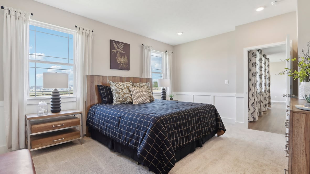 spacious primary bedroom with natural light