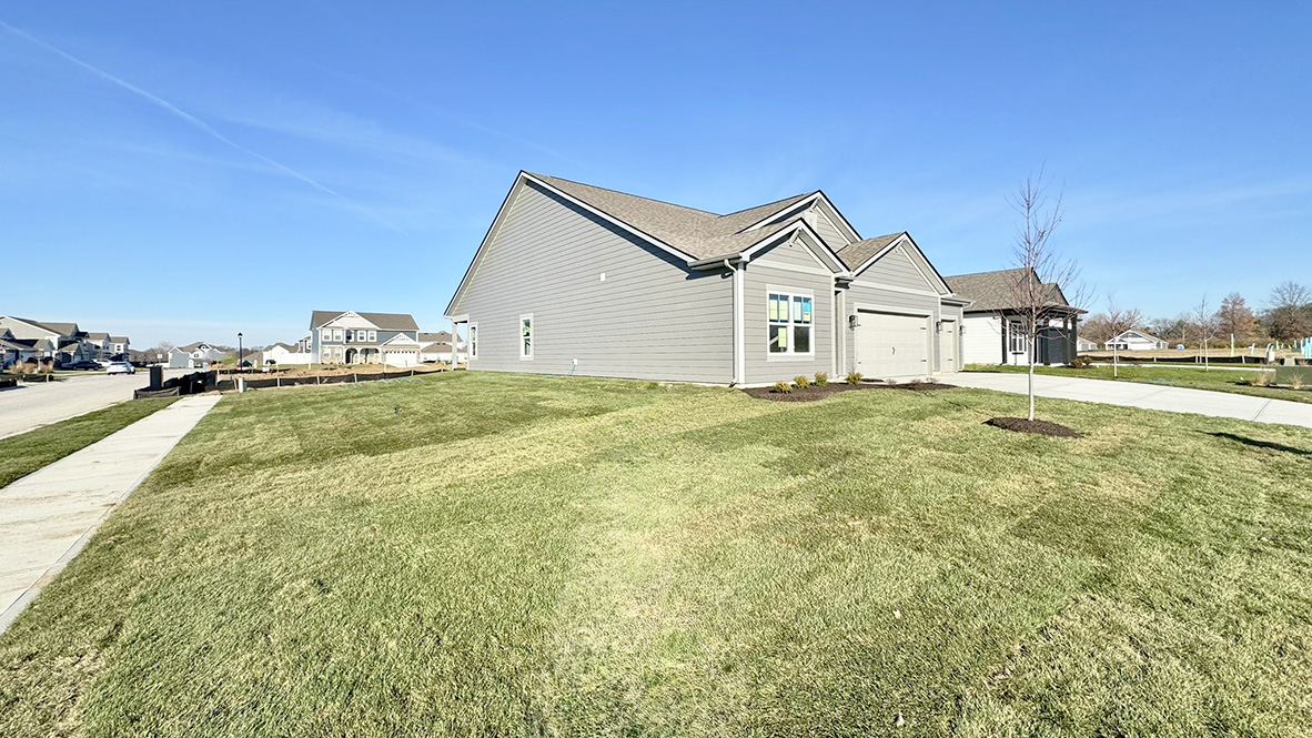 home placed on a corner homesite with large side yard.
