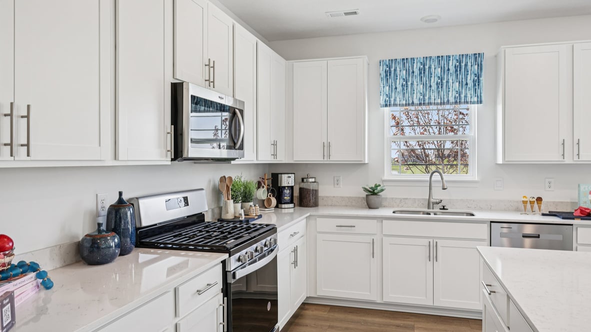 kitchen with white cabinetry, large island, and stainless steel appliances
