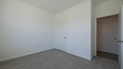 The guest bedroom offers easy access to the great room and kitchen.