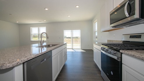 Kitchen features white cabinetry