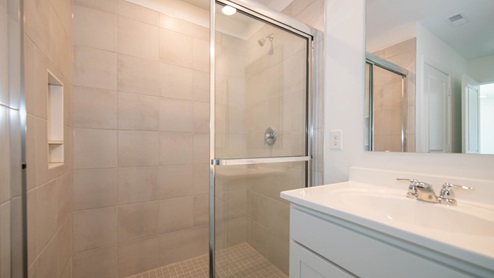 The primary bath offers a spacious standup shower