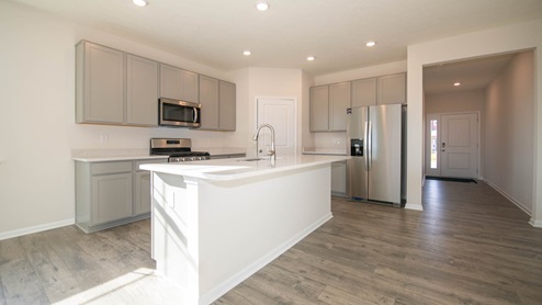 kitchen with gray cabinets and island