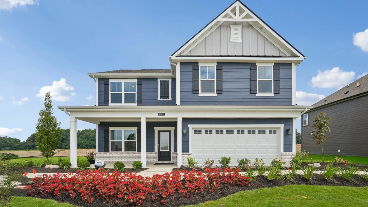 two story home with blue siding white brick beautiful landscaping