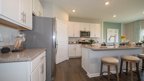 The kitchen offers beautiful cabinetry, quartz countertops, a large pantry and a built-in island with ample seating space.The kitchen offers beautiful cabinetry, quartz countertops, a large pantry and a built-in island with ample seating space.