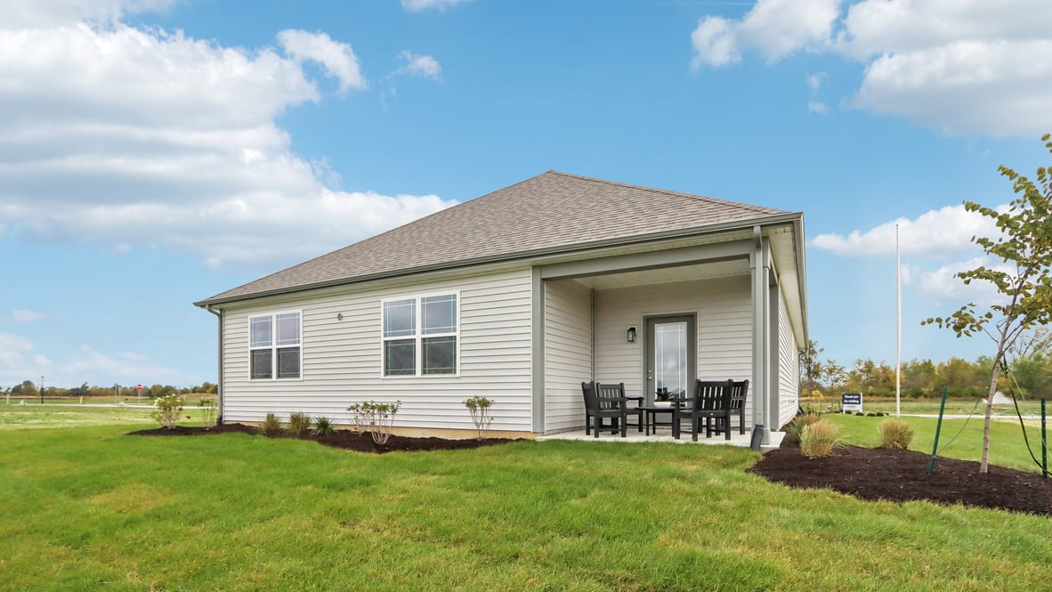 rear exterior view of the home with covered patio
