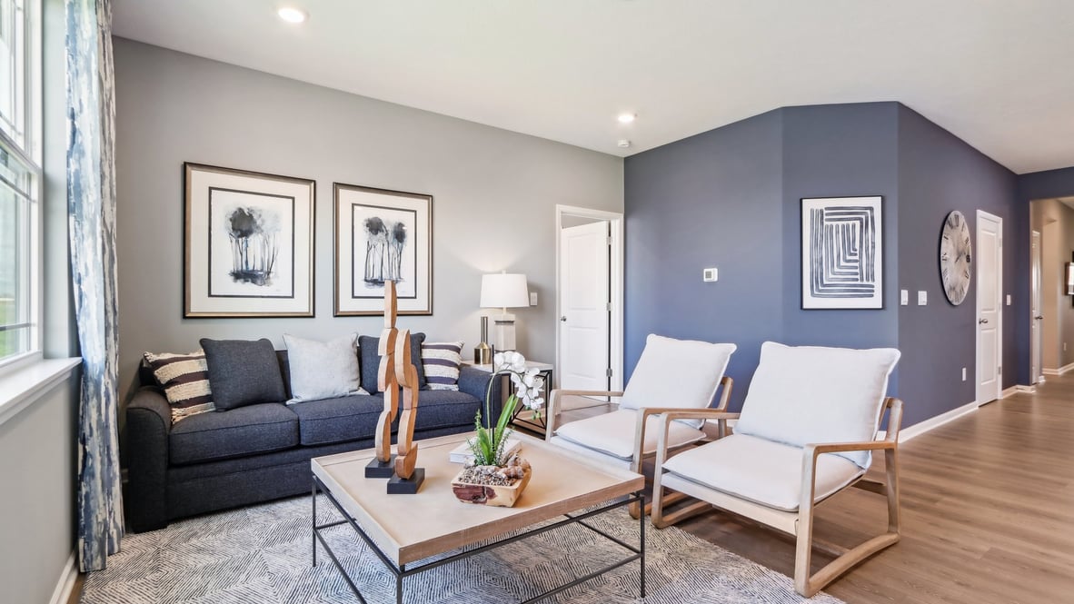 Living room features natural light, with fresh open concept looking to kitchen, front door foyer