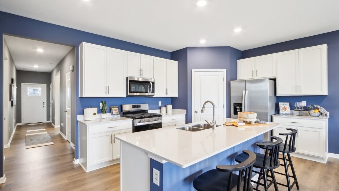Island kitchen layout with new appliance suite included, storage, pantry, sink, and functional prep zones