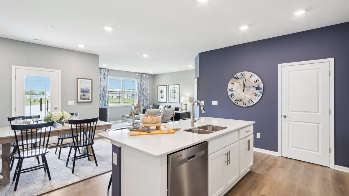 View from kitchen to dining and living areas with backyard and patio access Lone Pine Farms By D.R. Horton
