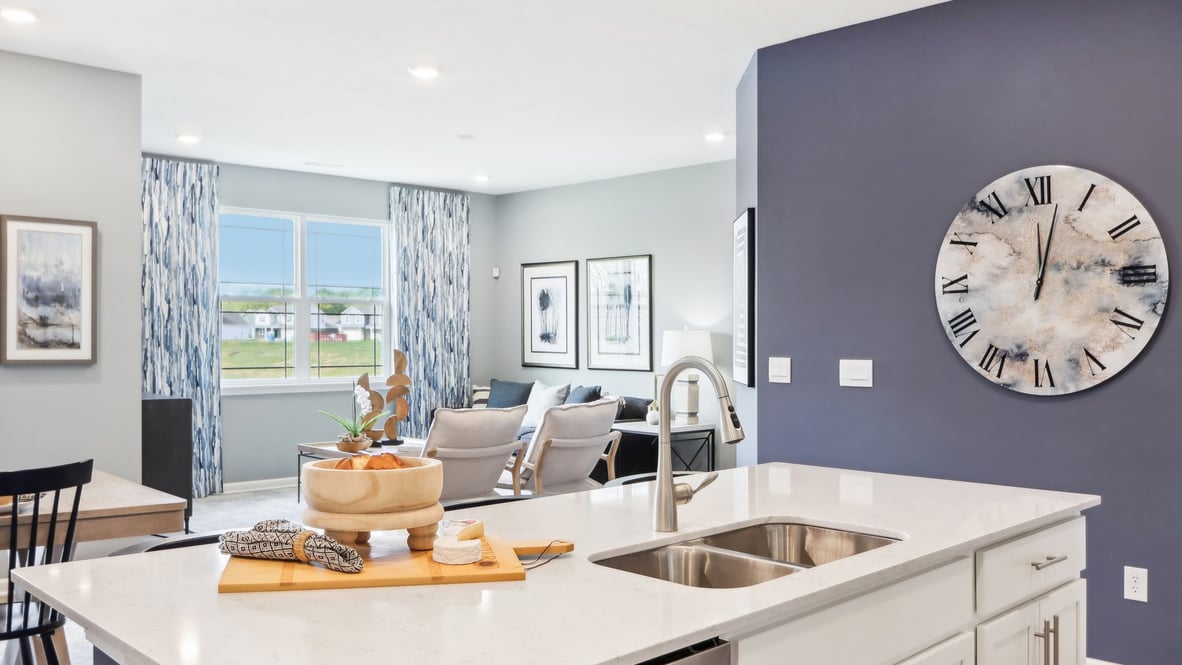 View from kitchen toward dining, living, and backyard areas with outdoor connection