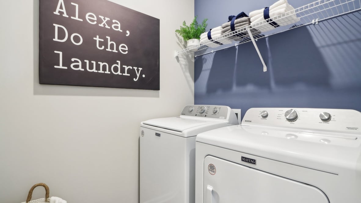 Utility laundry smartly designed with overhead storage, a drop zone, washer and dryer and hookups included