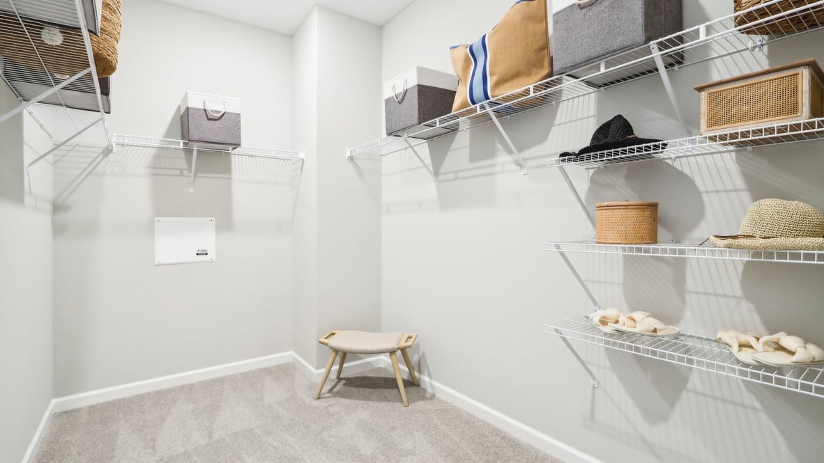Interior view of the walk-in closet connected to the primary bedroom with spa-inspired ensuite and generous storage