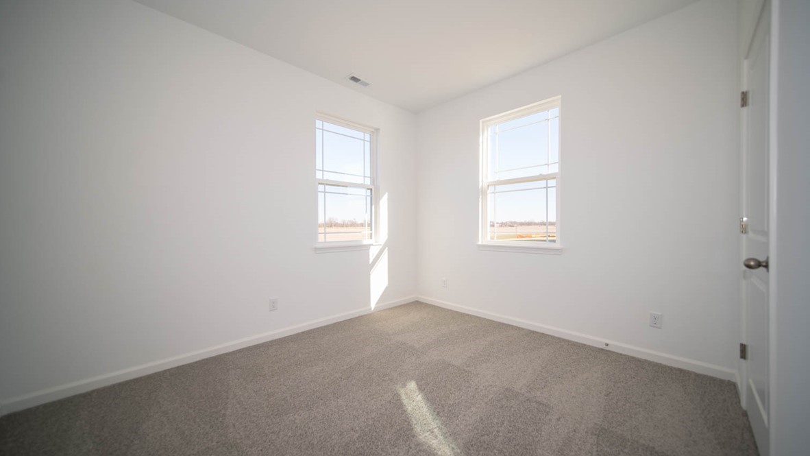guest bedroom with large windows