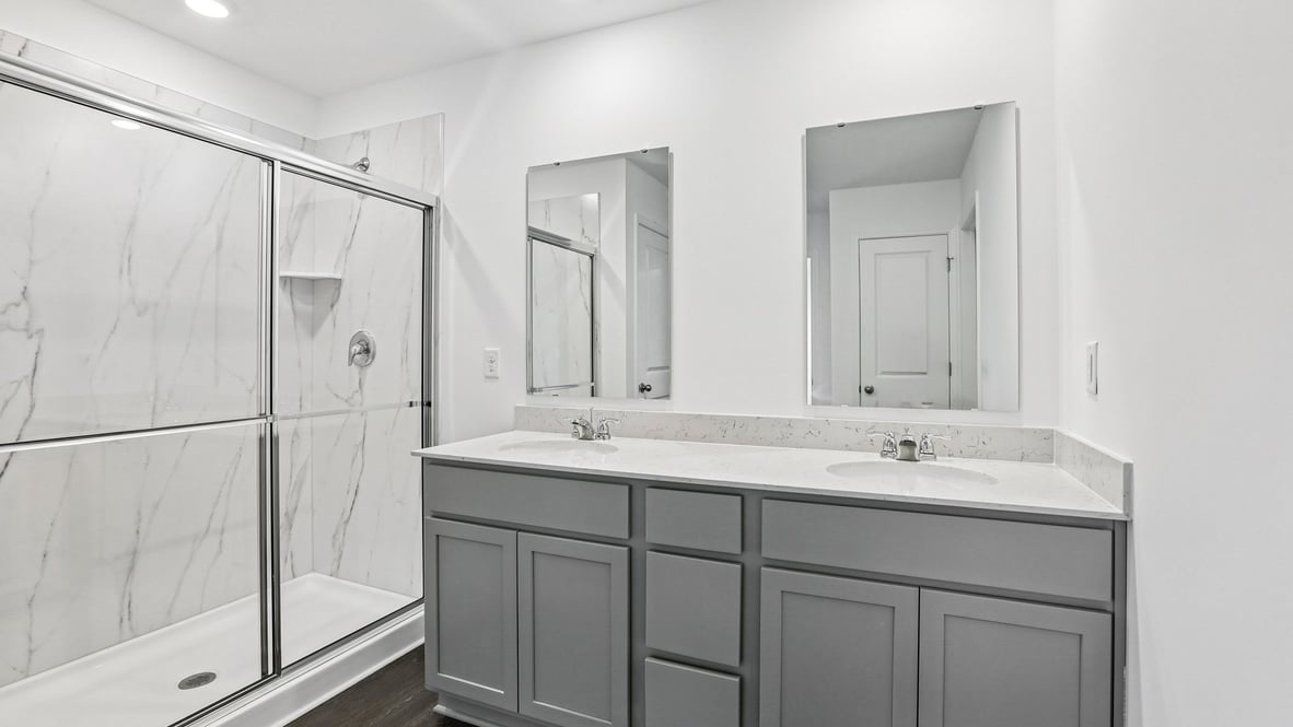 bathroom with gray cabinets and shower