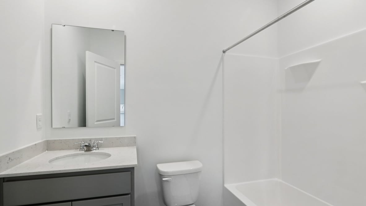 bathroom with a vanity sink, toilet and shower