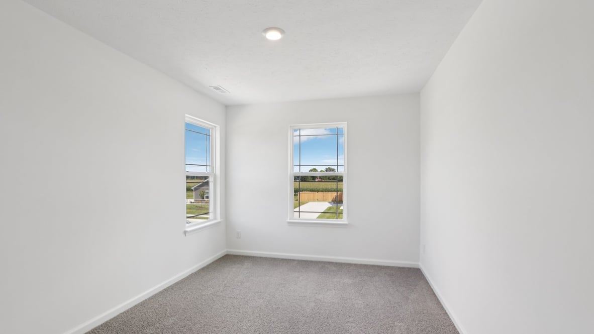 bedroom with grey carpet and white walls and a window