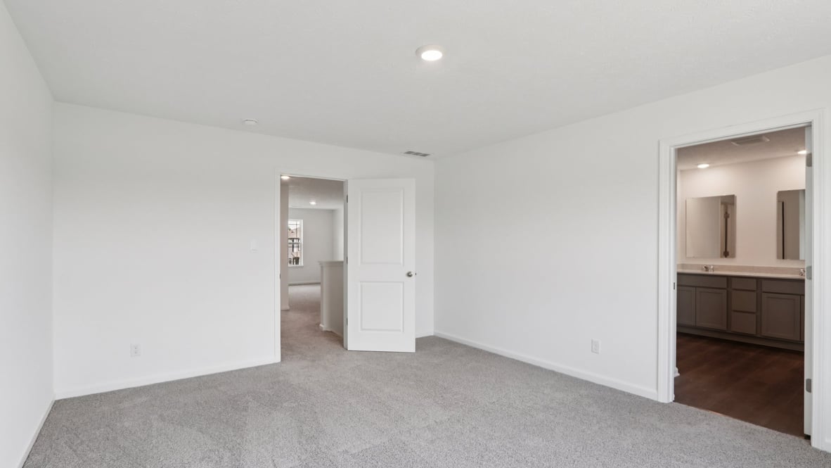 bedroom with grey carpet and white walls and a window