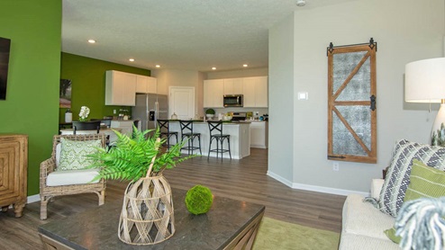 Modern open-concept great room and dining area with access to back patio door.