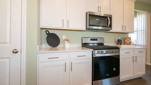 The kitchen offers beautiful cabinetry.