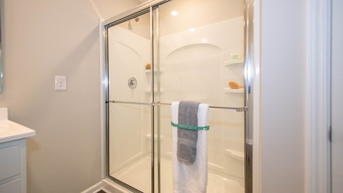 The primary bath offers a spacious standup shower