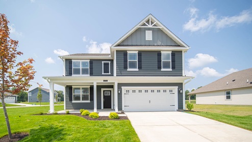 two story home with blue gray siding and 2 car garage