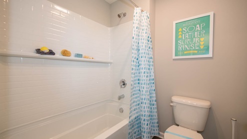 The hall bath includes a tub shower, dual sinks and private commode