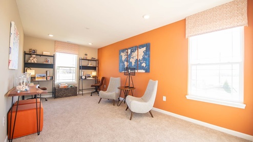 loft with orange accent wall, kids hangout space upstairs