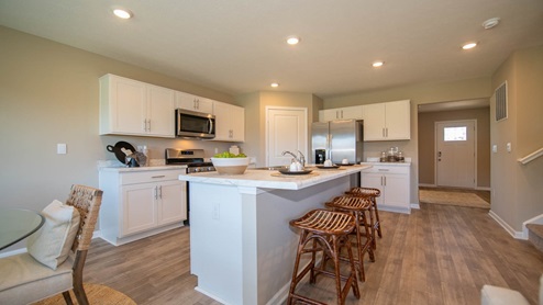 The kitchen offers beautiful cabinetry, a large pantry and a built-in island with ample seating space
