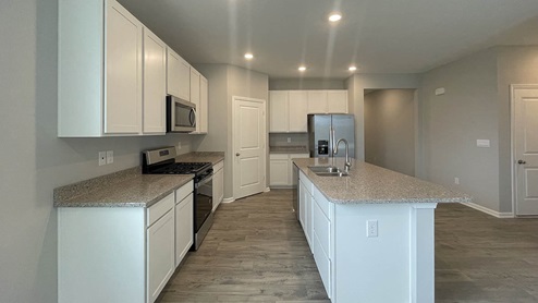kitchen with white cabinets and quartz countertops