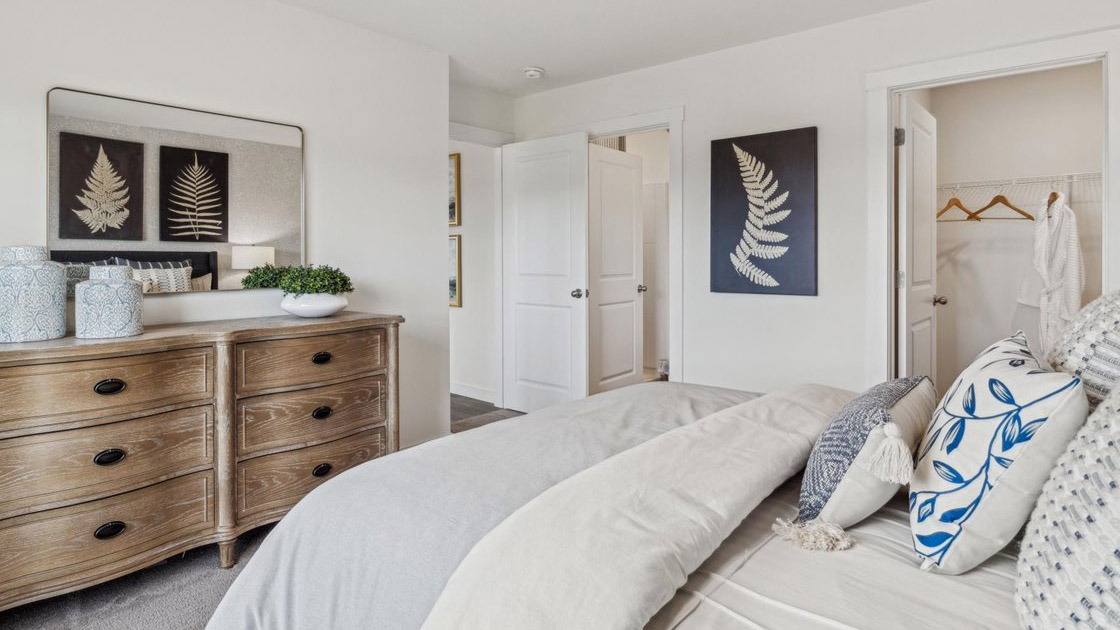 spacious primary bedroom with walk in closet and en suite bathroom