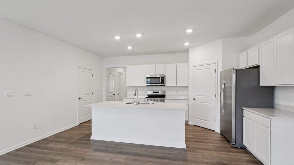 Kitchen showcasing cabinets, pantry storage, and a new appliance suite included