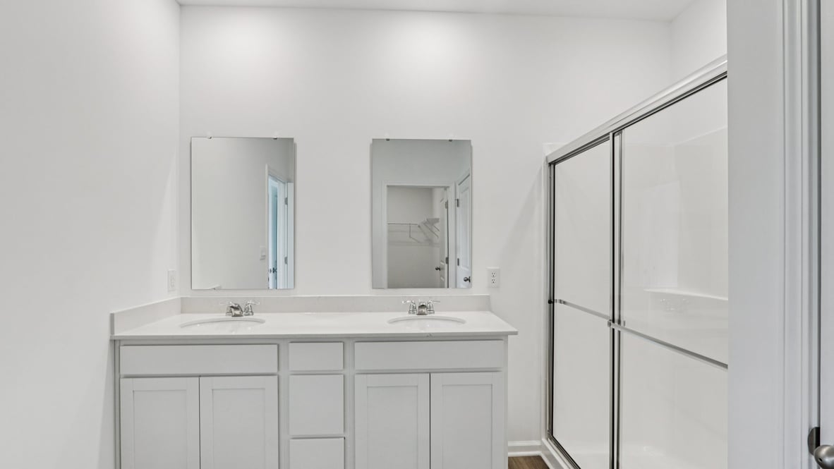 Owner’s ensuite featuring a dual vanity for organized daily routines