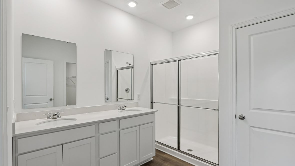 Owner’s ensuite showcasing vanity space and a walk-in shower