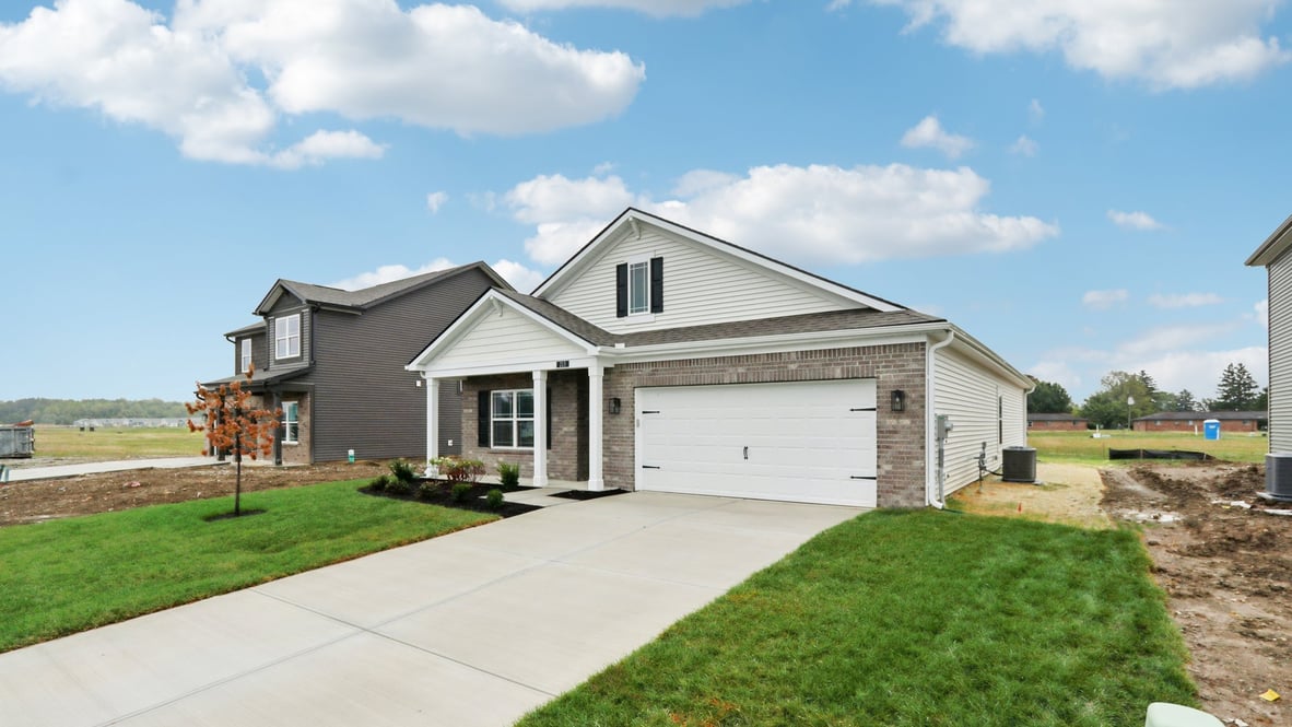 Left street view highlighting driveway, garage placement, and exterior finishes