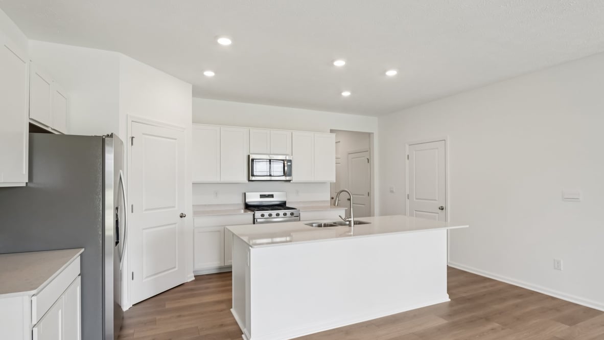 spacious kitchen with white cabinetry, and stainless steel appliances