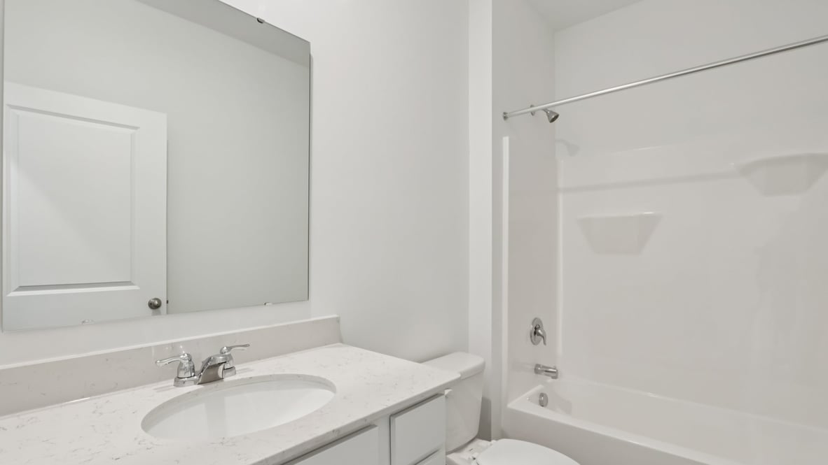 bathroom with a vanity sink, toilet and shower