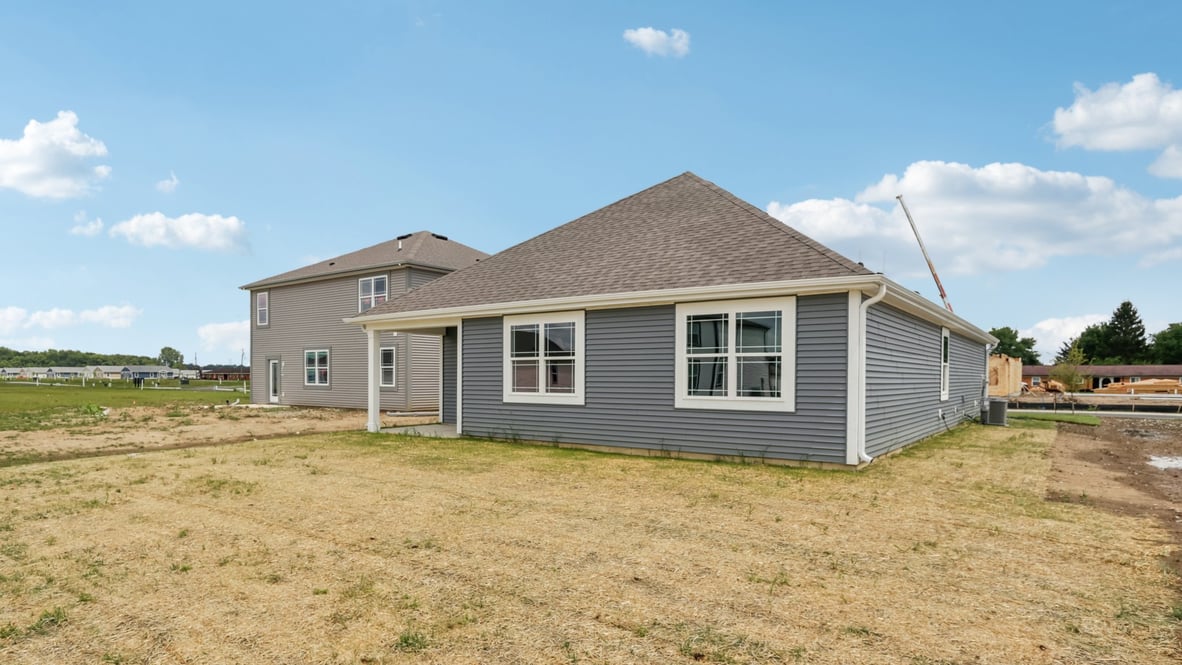 rear exterior of home featuring a covered concrete patio