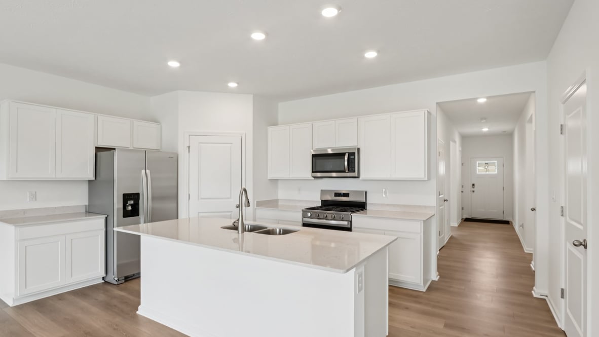 spacious kitchen with white cabinetry, and stainless steel appliances