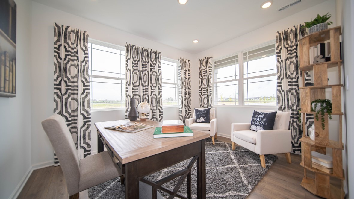 den or home office with desk and two chairs