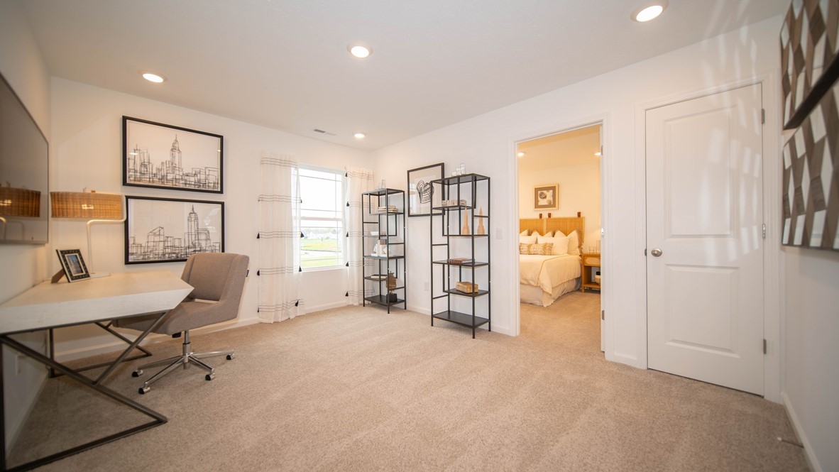 loft space on upper level with desks chairs and shelving